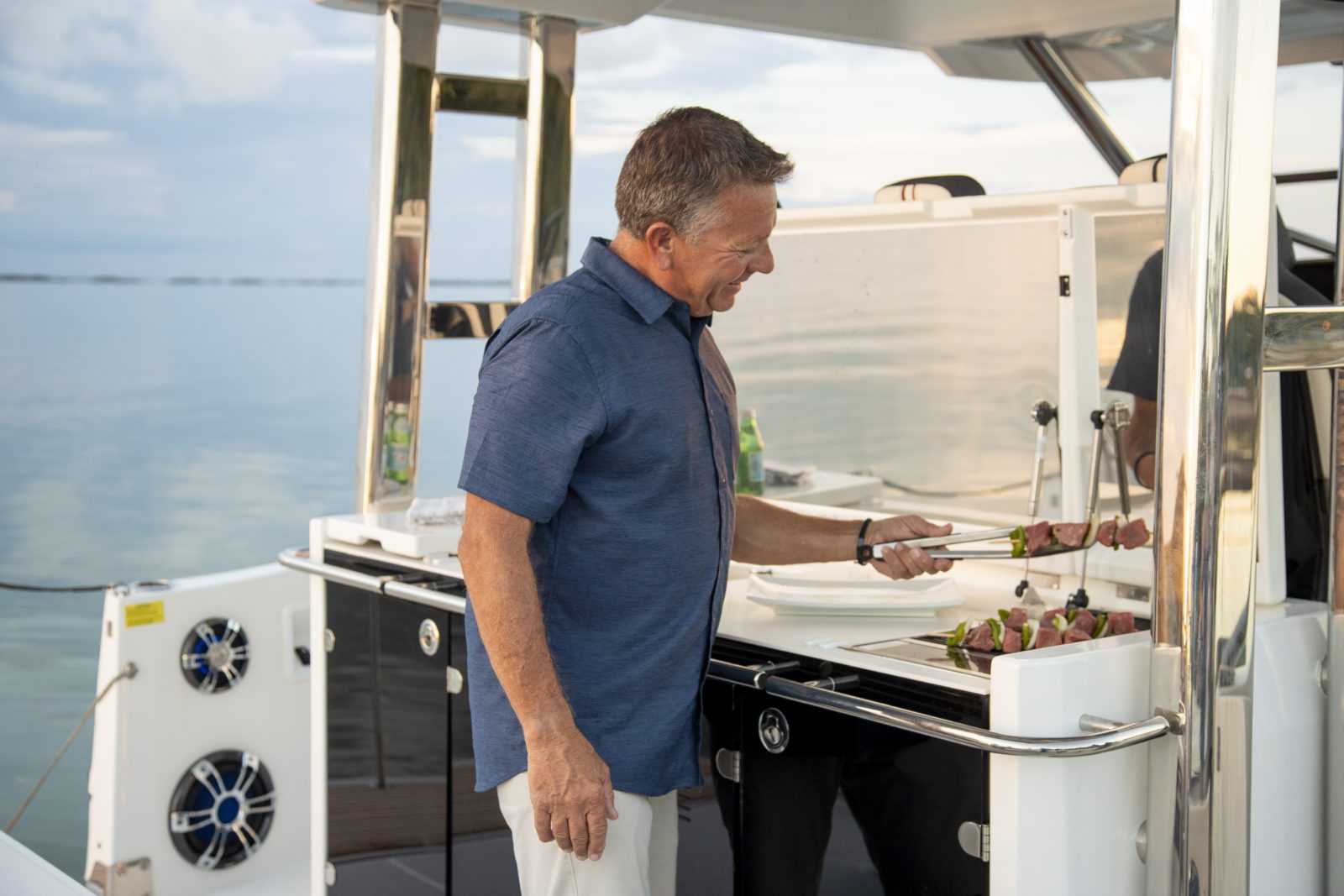 Man cooking on Cap Camrat 12.5WA